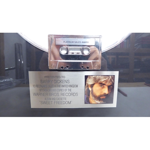 73 - A platinum sales award, presented to one Barry Dickens, celebrating over 300,000 sales of Michael Mc... 