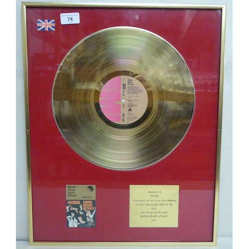 74 - A gold disk, presented to MAM, celebrating £250,000 worth of sales for Queen's 'Sheer Heart Attack' ... 