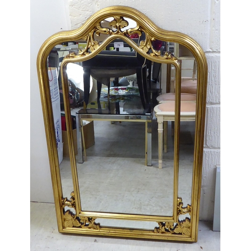 75 - A modern mirror, the segmented shaped plate set in a moulded gilt frame  42