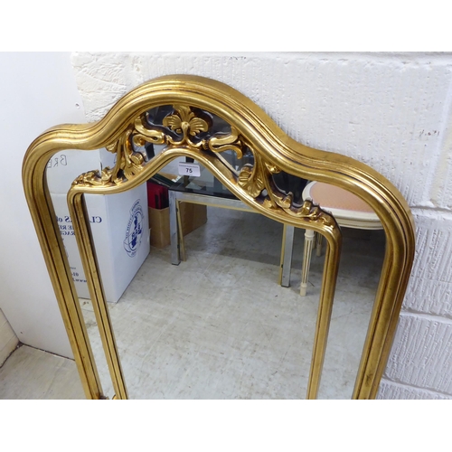 75 - A modern mirror, the segmented shaped plate set in a moulded gilt frame  42