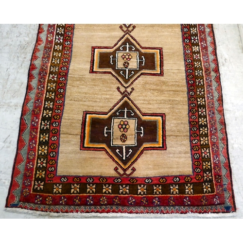 78 - A Turkish rug, decorated with repeating central designs and stylised border, on a multi-coloured gro... 