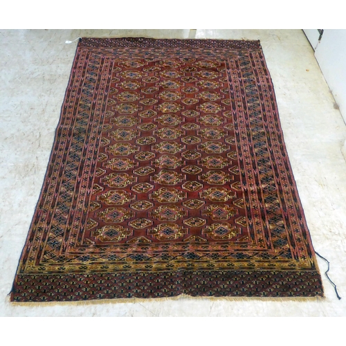 79 - A Bokhara rug, decorated with columns of guls and stylised border, on a red ground  50