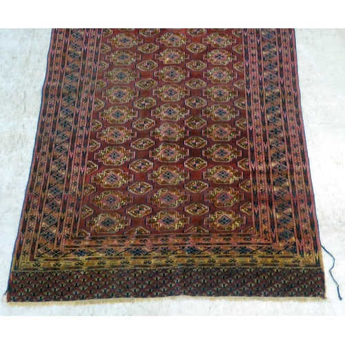 79 - A Bokhara rug, decorated with columns of guls and stylised border, on a red ground  50