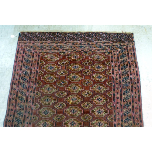 79 - A Bokhara rug, decorated with columns of guls and stylised border, on a red ground  50