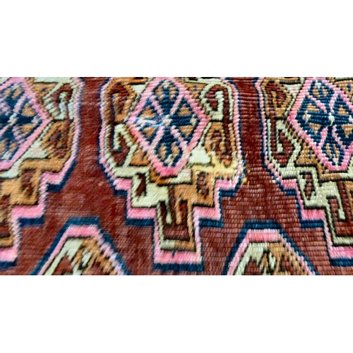 79 - A Bokhara rug, decorated with columns of guls and stylised border, on a red ground  50