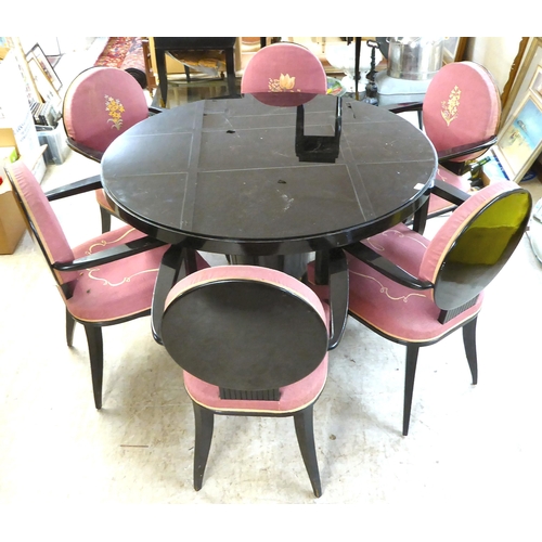 83 - A modern black painted pedestal dining table with a glass inset top  29.5