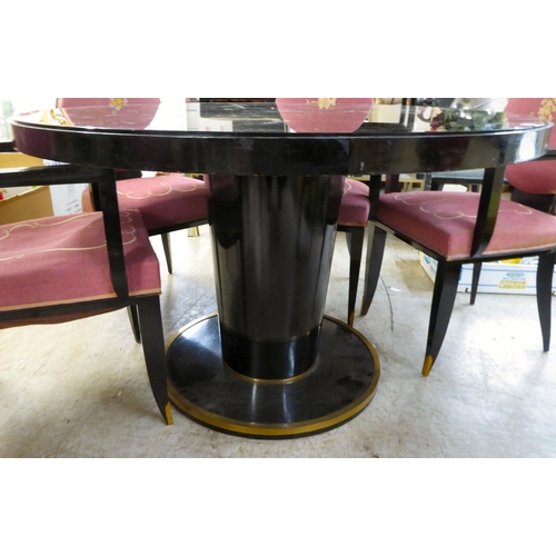 83 - A modern black painted pedestal dining table with a glass inset top  29.5