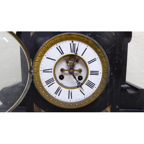 86 - A late Victorian slate cased mantel clock, on a plinth; the movement faced by a Roman dial  18