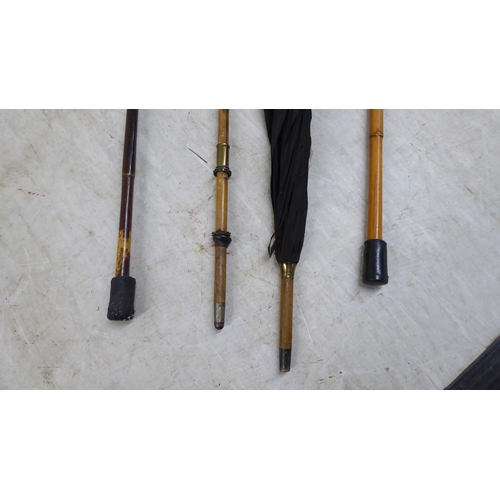 89 - Four wooden walking canes/umbrellas, one with a 9ct gold cap