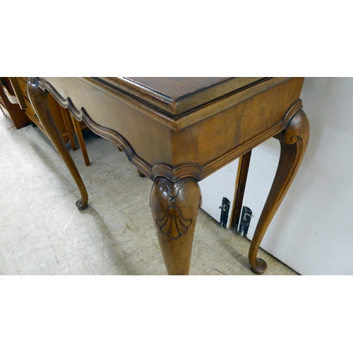 92 - An early 20thC mahogany card table, the foldover top raised on cabriole legs  29