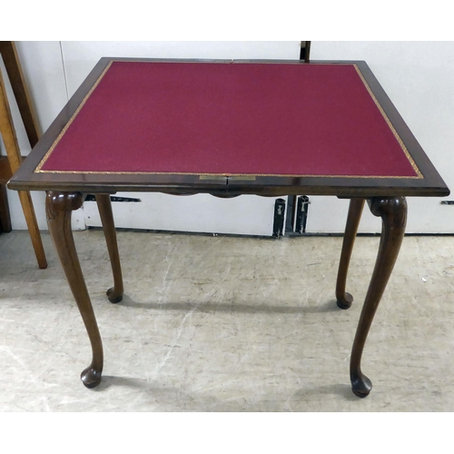 92 - An early 20thC mahogany card table, the foldover top raised on cabriole legs  29