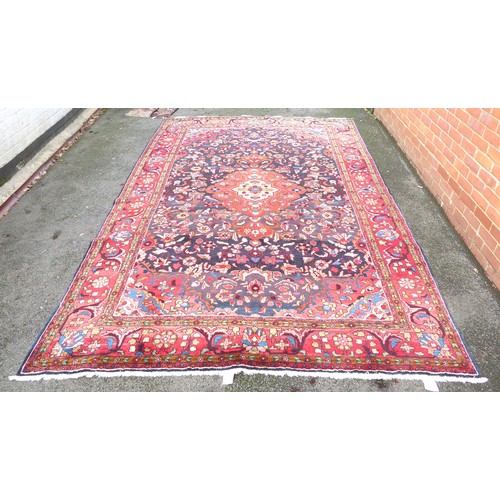 82 - A Persian carpet, decorated with floral and foliage designs, on a multi-coloured ground  94