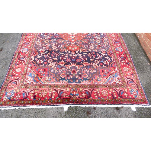 82 - A Persian carpet, decorated with floral and foliage designs, on a multi-coloured ground  94