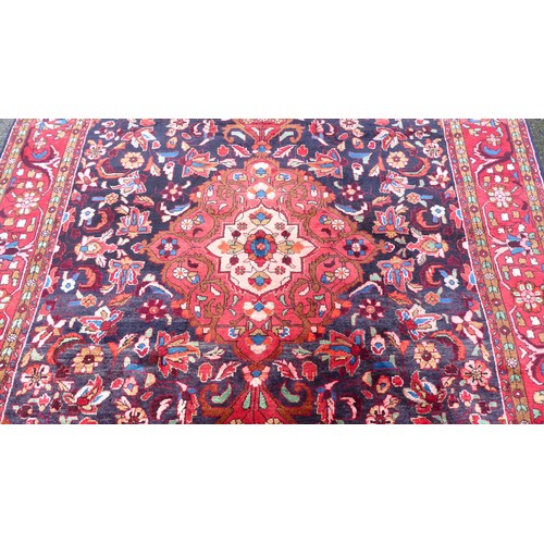 82 - A Persian carpet, decorated with floral and foliage designs, on a multi-coloured ground  94