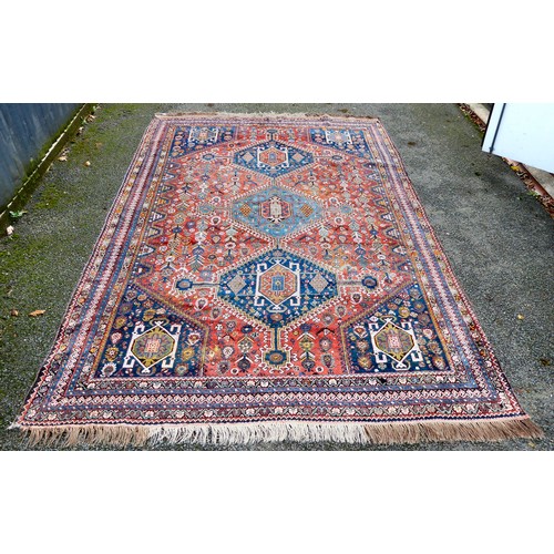 81 - A Shiraz carpet, profusely decorated with repeating stylised designs, on a multi-coloured ground  80... 