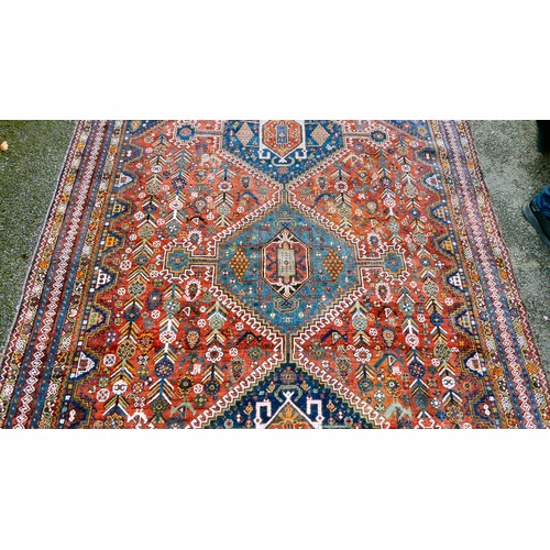 81 - A Shiraz carpet, profusely decorated with repeating stylised designs, on a multi-coloured ground  80... 