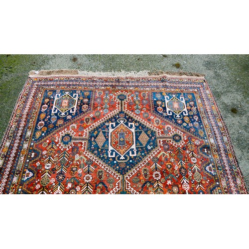 81 - A Shiraz carpet, profusely decorated with repeating stylised designs, on a multi-coloured ground  80... 