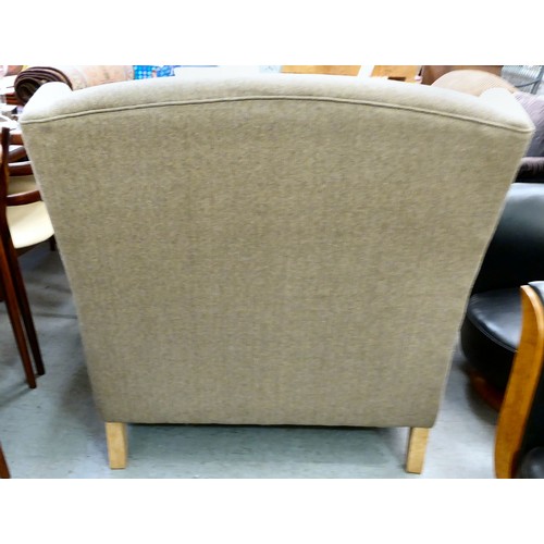 439 - A modern grey fabric upholstered oversize, wingback chair, raised on block feet