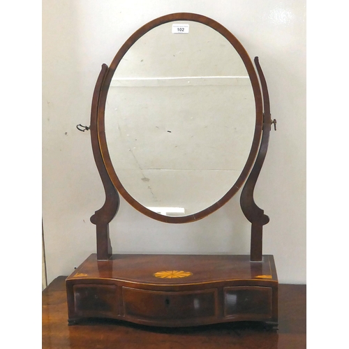 102 - A late George III string inlaid crossbanded, rosewood veneered dressing table mirror, the oval portr... 