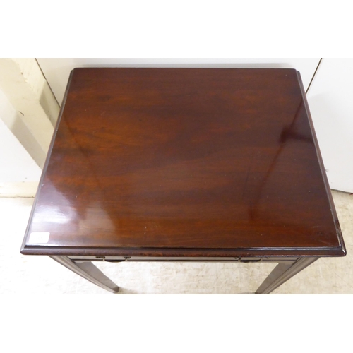 105 - A 19thC mahogany single drawer side table, raised on square, tapered legs  27