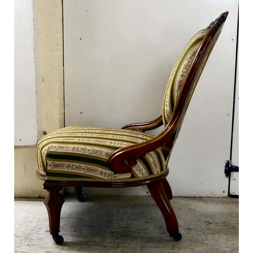 115 - A late Victorian walnut, showwood framed and later fabric upholstered nursing chair, raised on taper... 