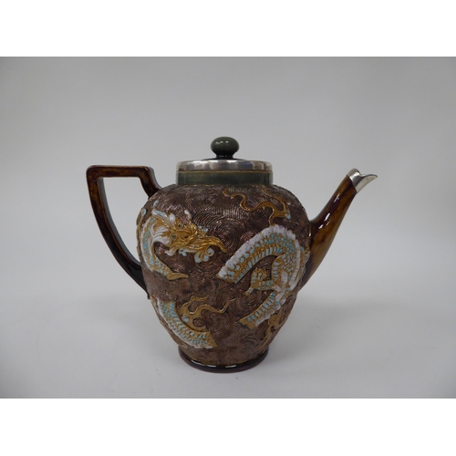 119 - A late Victorian Doulton Lambeth stoneware teapot of ovoid form with a silver collar and spout termi... 