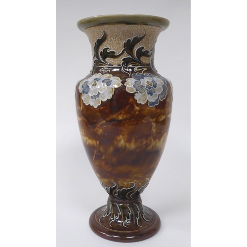 121 - A late Victorian Doulton Lambeth stoneware vase of ovoid pedestal form, decorated in colours with st... 