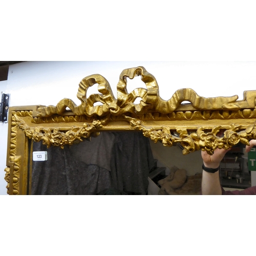 123 - A 19thC mirror, the plate set in a ribbon, rose and breakfront moulded gilt frame  37