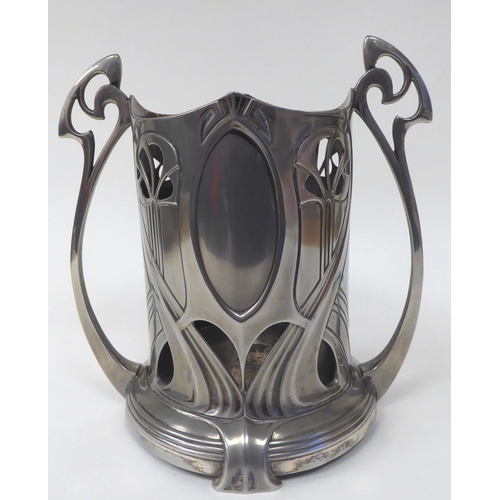 124 - An Art Nouveau pewter twin handled bottle coaster, decorated with typically flowing lines  bears imp... 