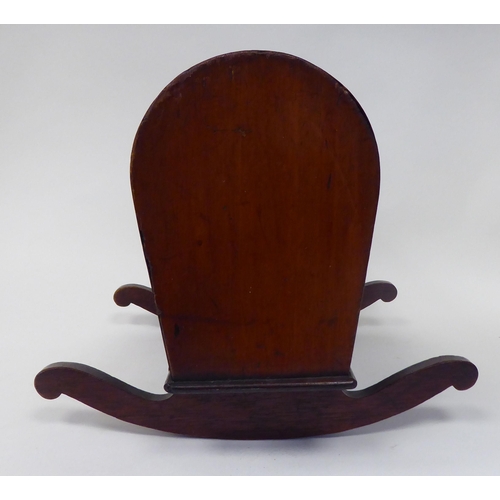 13 - An antique finished, mahogany miniature crib, fashioned as a planter, on a rocker base  18