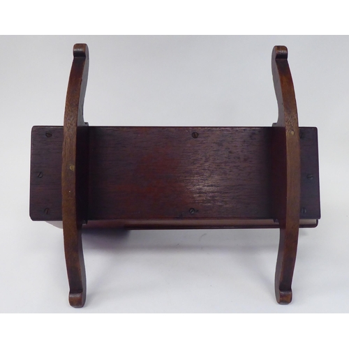 13 - An antique finished, mahogany miniature crib, fashioned as a planter, on a rocker base  18