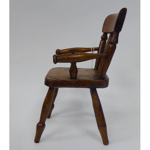 13 - An antique finished, mahogany miniature crib, fashioned as a planter, on a rocker base  18