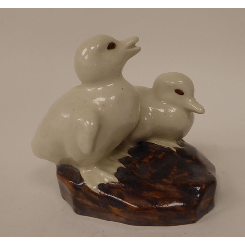 131 - A Royal Doulton china model, two white chicks, on a rock  bears an indistinctively impressed ma... 