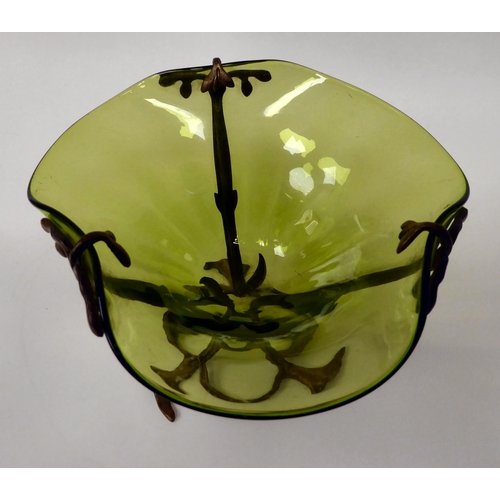 134 - An Art Nouveau tinted green freeform glass lily vase, set in a naturalistically cast brass frame&nbs... 