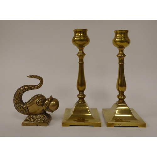 171 - A late Victorian brass desktop paperweight, fashioned as a dolphins' head with a sphere; and a pair ... 