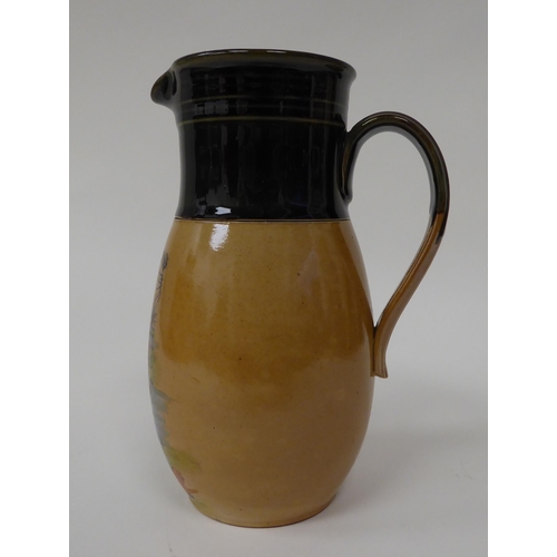 176 - An early 20thC brown and green stoneware jug, decorated with a little boy emerging from a stream, be... 