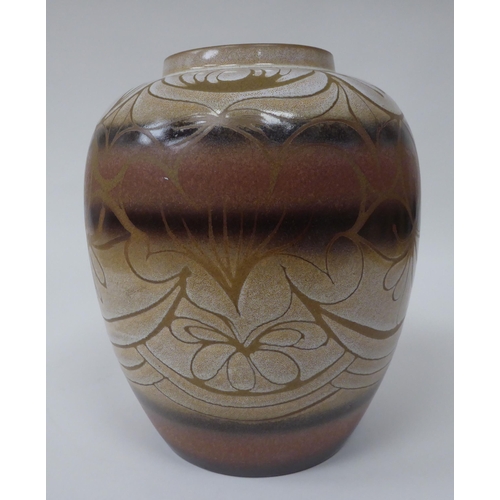 178 - A Poole pottery baluster shape jar, decorated in brown and cream colours with floral designs  bears ... 