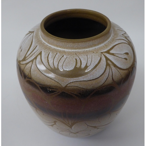 178 - A Poole pottery baluster shape jar, decorated in brown and cream colours with floral designs  bears ... 