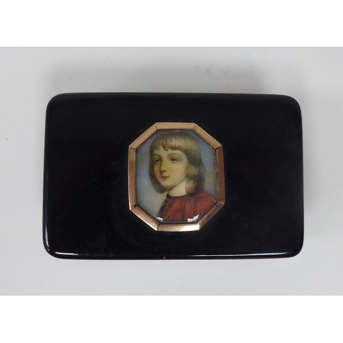 179 - A 19thC black stained horn snuff box with concave sides, a hinged lid and yellow metal mounts, displ... 