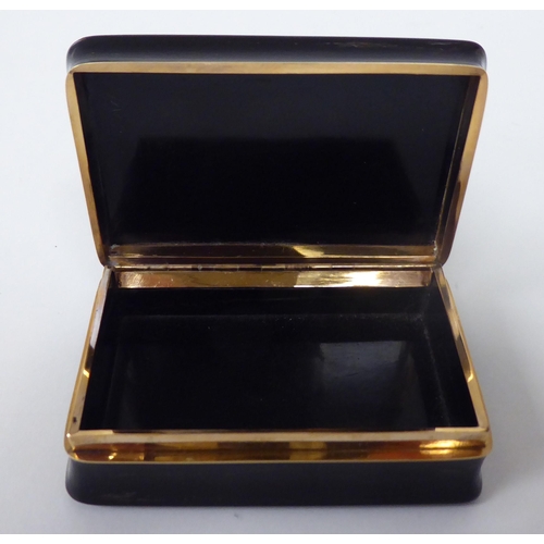 179 - A 19thC black stained horn snuff box with concave sides, a hinged lid and yellow metal mounts, displ... 