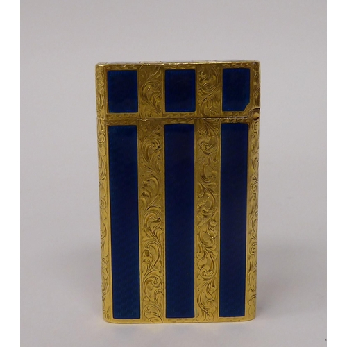 184 - A yellow metal and blue enamel, gas filled cigarette lighter with finely scroll engraved decoration