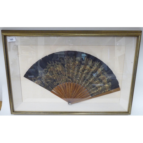 185 - A 19thC Sino-European fan with decoratively carved guards and a gilded and painted leaf  11