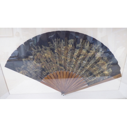 185 - A 19thC Sino-European fan with decoratively carved guards and a gilded and painted leaf  11