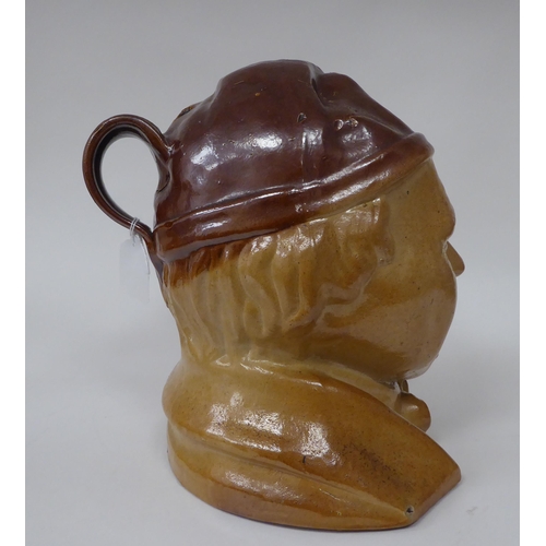 19 - A late 19thC two tone brown salt glazed earthenware novelty jug, fashioned as a smiling man, wearing... 