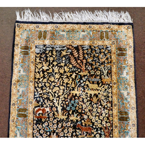 200 - A modern Persian inspired part silk rug, decorated in colours with animals, birds and floral designs... 