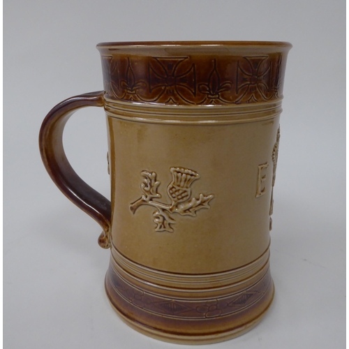 201 - A Doulton two tone brown stoneware mug, decorated to celebrate the Coronation of Queen Elizabeth in ... 