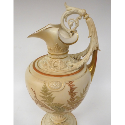 202 - A Royal Worcester blush ivory glazed, moulded and part gilded china ewer of ovoid form with a foliat... 