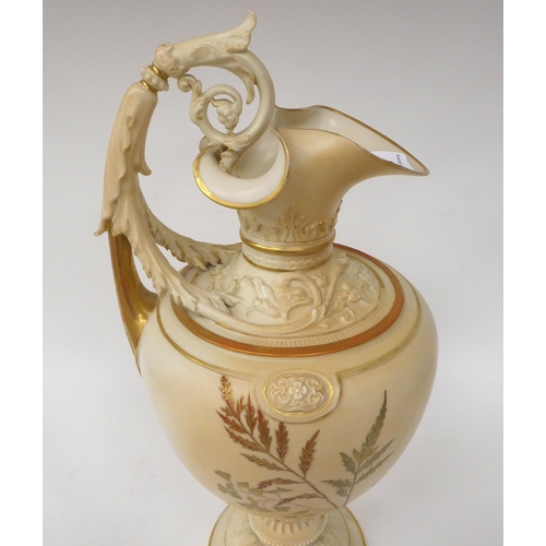 202 - A Royal Worcester blush ivory glazed, moulded and part gilded china ewer of ovoid form with a foliat... 