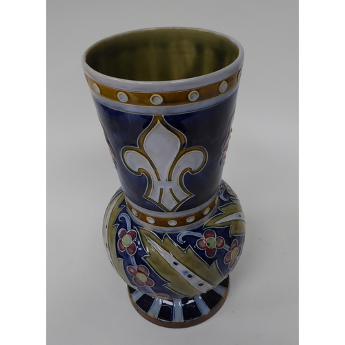 206 - An early 20thC Doulton Lambeth stoneware vase, decorated in colours with red roses and other designs... 