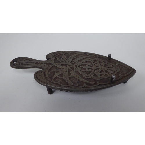 209 - A 19thC Christopher Dresser design smoothing iron stand by A Kendrick & Sons, decorated with eng... 